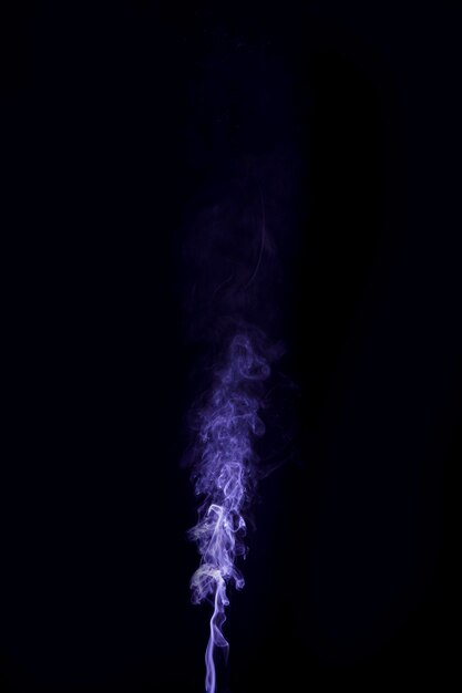 Фиолетовый дым кружится на черном фоне