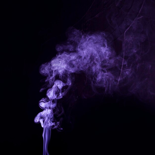 Purple smoke textured spread on black background