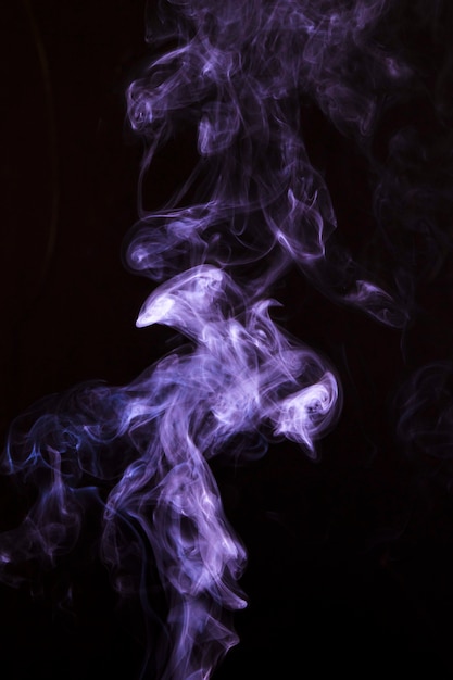Purple smoke twirling over a dark background