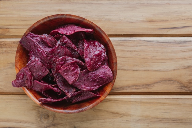 Purple sweet potato in the cup, placed on a brown wood floor.