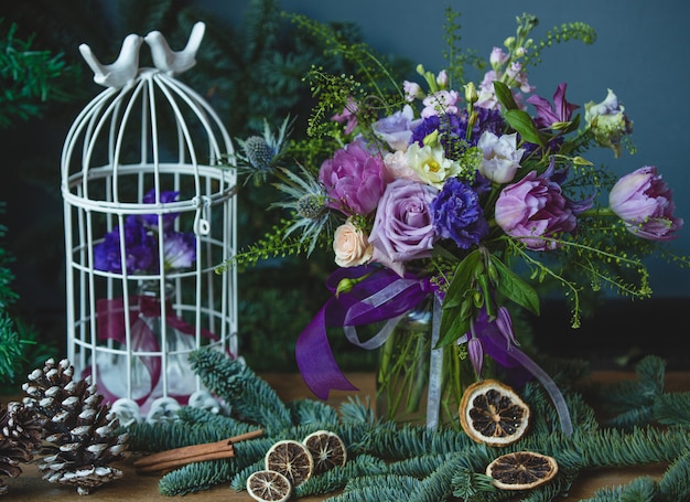 Purple tones colored flower bouquet with christmas decorations.