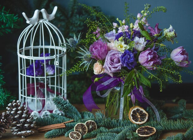 Purple tones colored flower bouquet with christmas decorations.