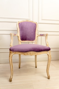 Purple vintage classical farbirc style chair indoors.