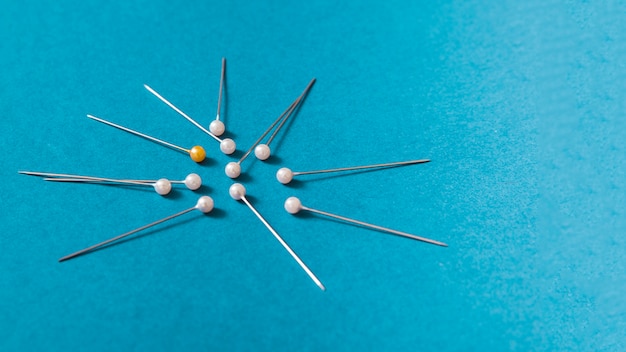 Push pins on blue background