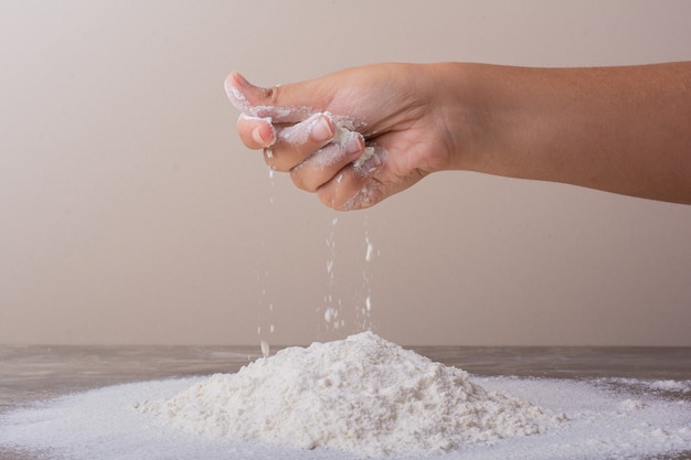 Putting all purpose flour to make dough