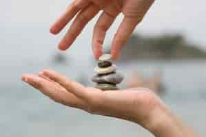 Free photo putting the last pebble on a pile of stones