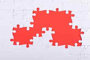 Free photo puzzle pieces and red background