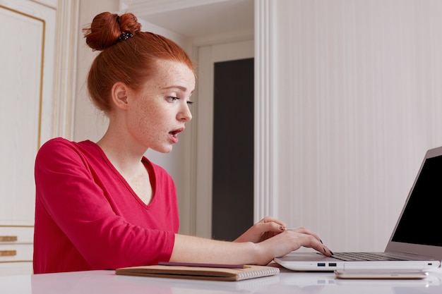 Puzzled female talented editor of online issue works remotely at home