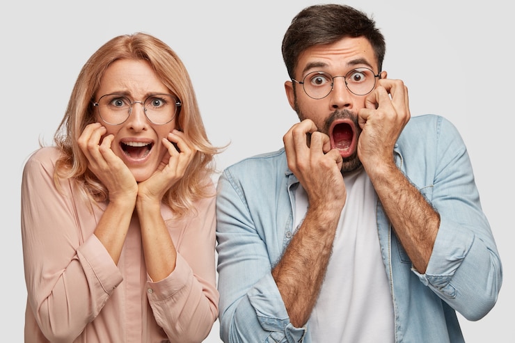 Free Photo puzzled nervous scared woman and man business partners react on lowering sales and having financial debts