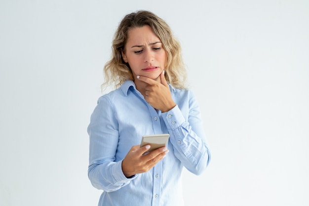 Puzzled phone user getting concerning news