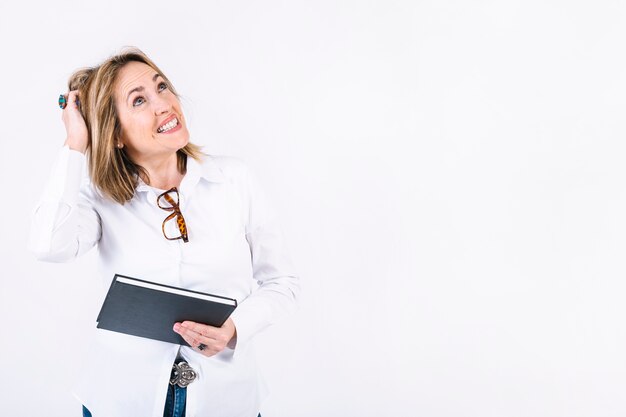 Puzzled woman with notebook