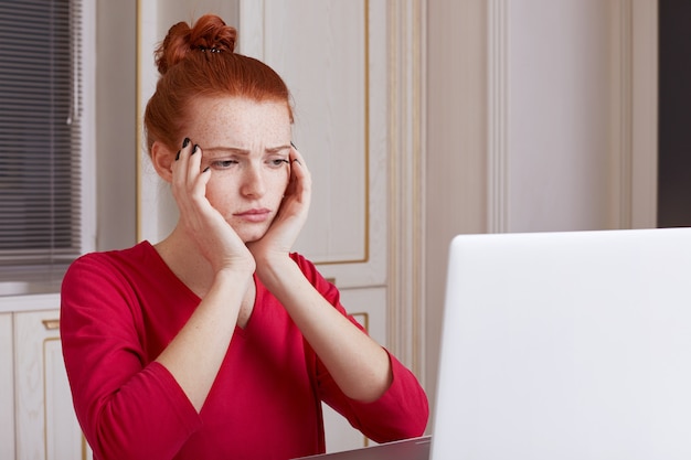 Puzzled young female student prepares for exams during last day