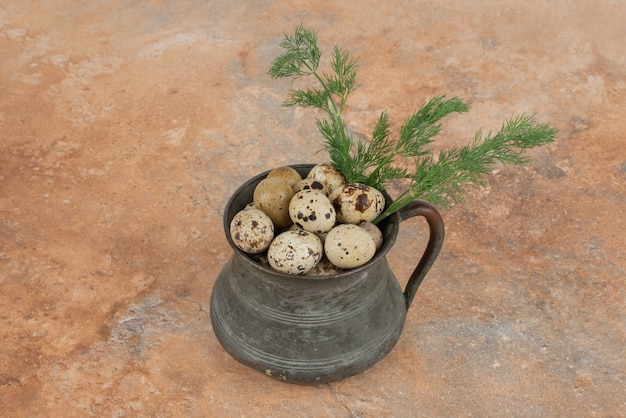 Quail eggs on the cup in the marble table .