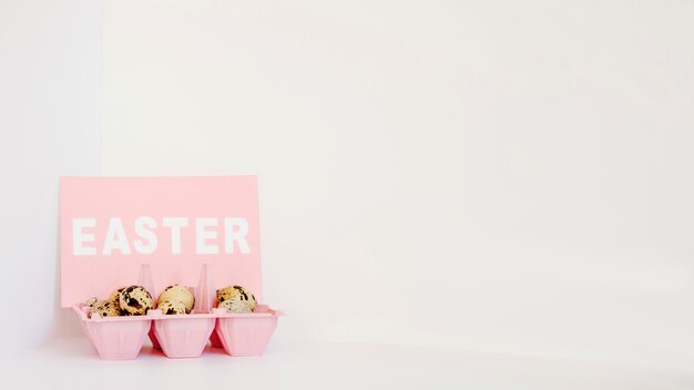 Quail eggs and Easter paper in rack