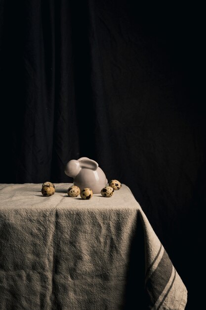 Quail eggs and figure of rabbit on table