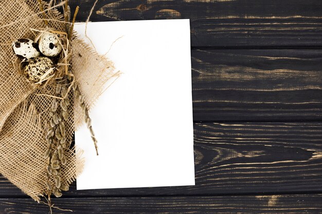 Quail eggs near paper sheet