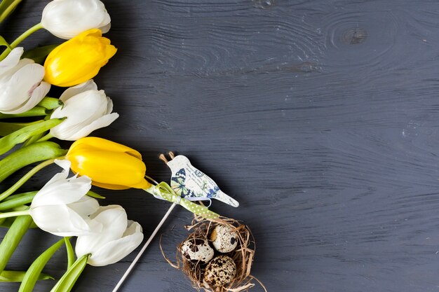 Quail eggs near tulips