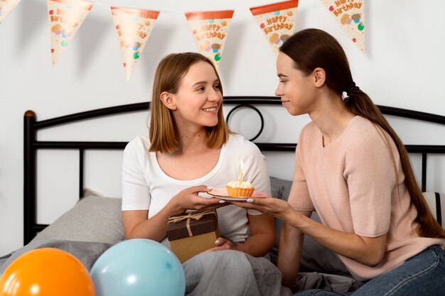 Queer couple celebrating birthday together