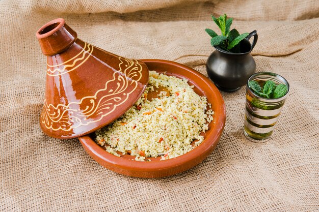 Quinoa salad in bowl near cup and pitcher