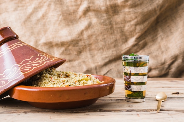 Free photo quinoa salad near cup on table