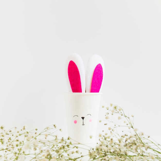 Free photo rabbit paper cup and green