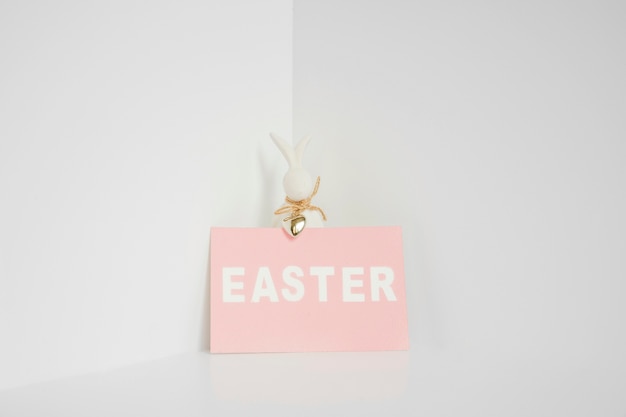 Free photo rabbit statuette and easter paper