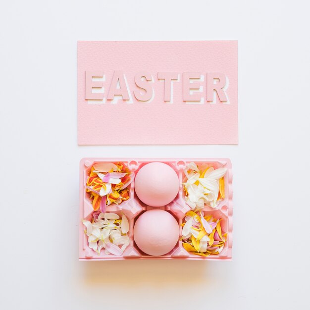 Rack with pink eggs at Easter word