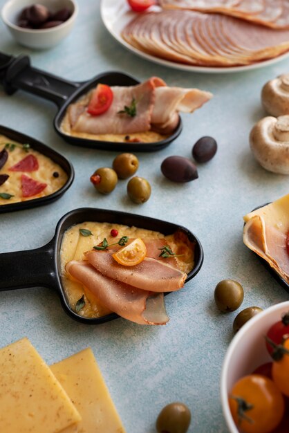 Raclette dish made with cheese and assortment of delicious food