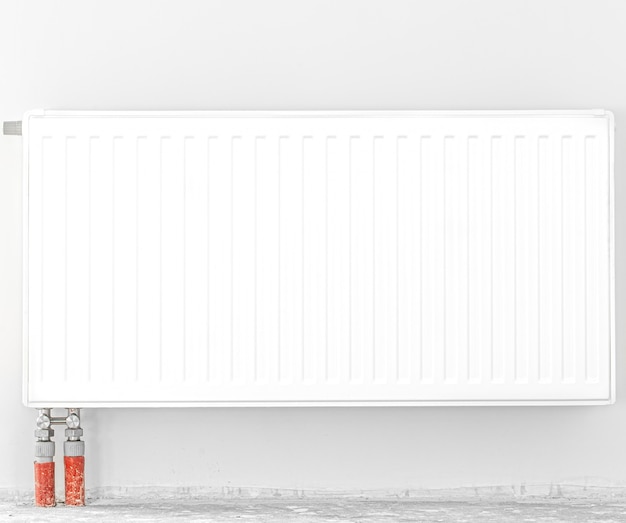 Radiator in front of a white wall. Front view.