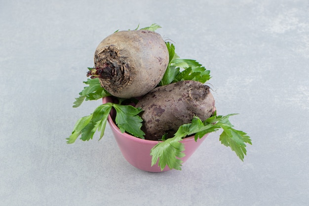 Free photo radish in bowl full to the brim , on the marble background.