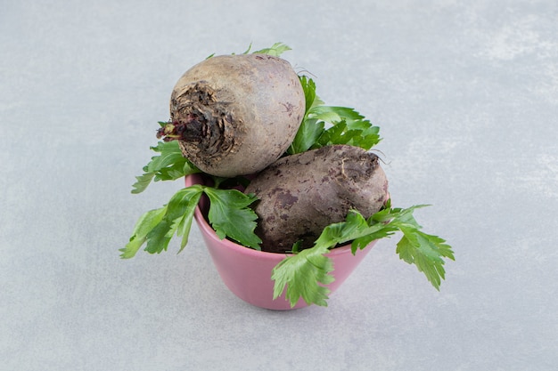 Radish in bowl full to the brim , on the marble background.