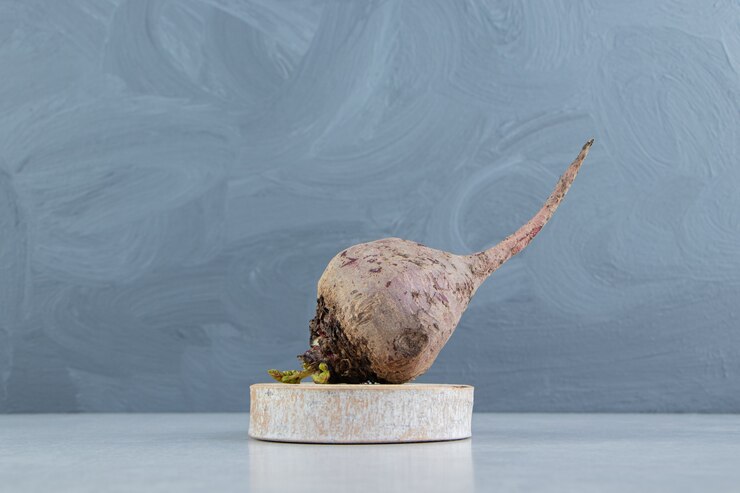 Free Photo radish on the wooden trivet , on the marble.