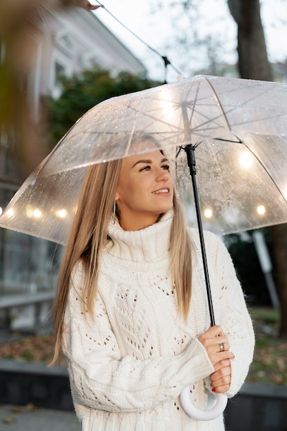 Free photo rain portrait of young and beatiful woman with umbrella