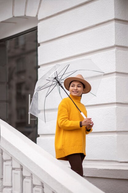 Rain portrait of young and beatiful woman with umbrella