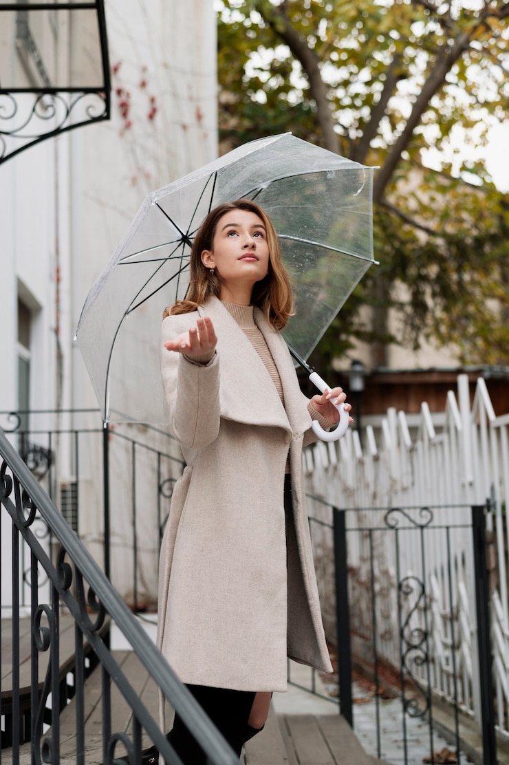 Free Photo rain portrait of young beautiful woman with umbrella