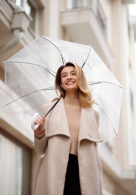 Foto gratuita ritratto di pioggia di giovane bella donna con ombrello