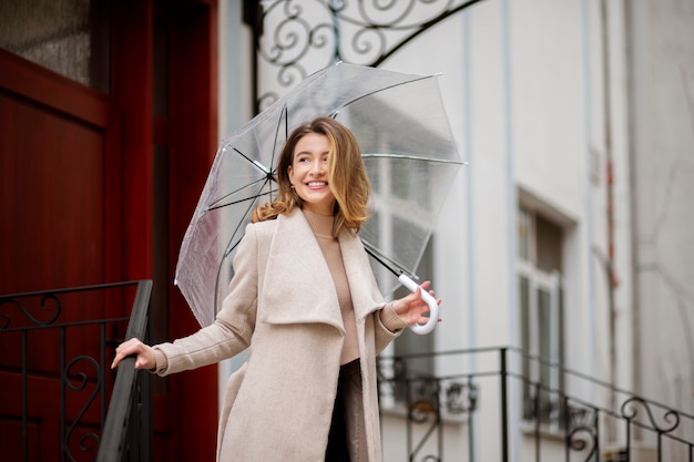 Rain portrait of young beautiful woman with umbrella