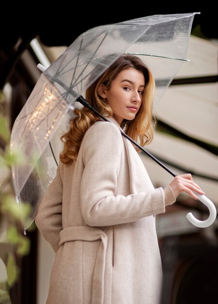 Rain portrait of young beautiful woman with umbrella