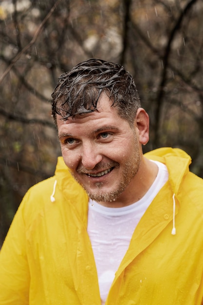 Free photo rain portrait of young man in rain coat