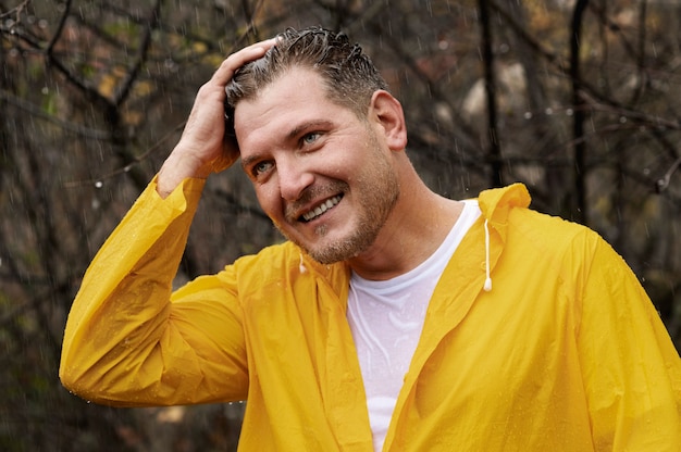 Free photo rain portrait of young man in rain coat