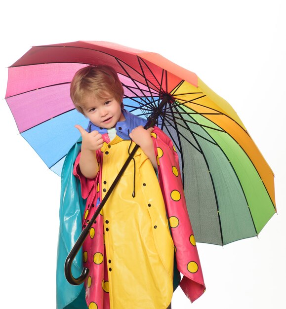 Rain and umbrella concept autumn clothing portrait of a beautiful happy little boy closeup cute litt...