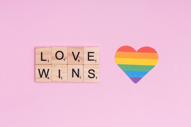 Free photo rainbow heart and lgbt slogan love wins