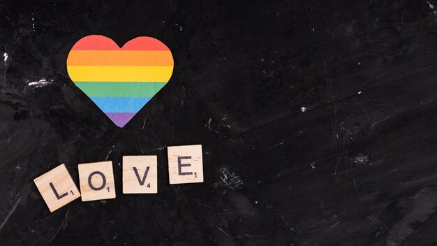 Rainbow LGBT heart with LOVE sign on black space background