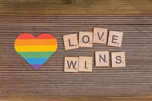 Free photo rainbow lgbt heart with love wins sign