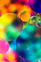 Free photo rainbow oil drops on a water surface abstract background