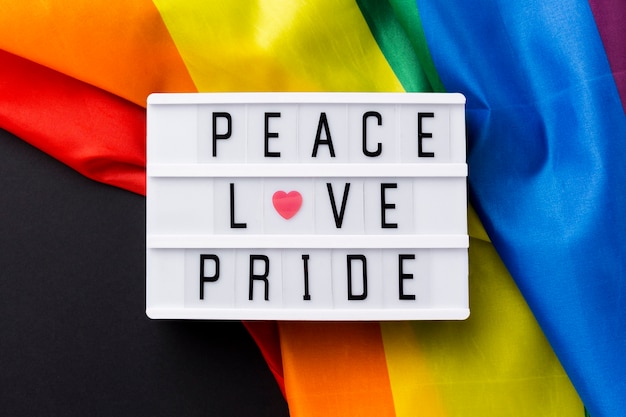 Rainbow pride flag and "peace love pride" quote close-up