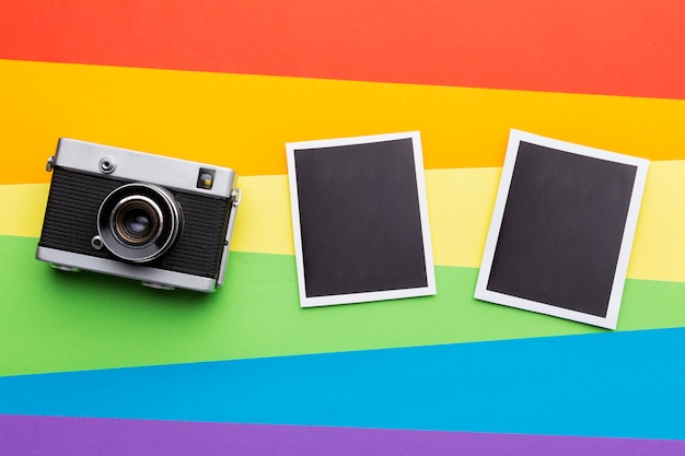 Rainbow pride flag with vintage camera and photos