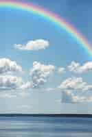 Free photo rainbow in the sky with nature landscape