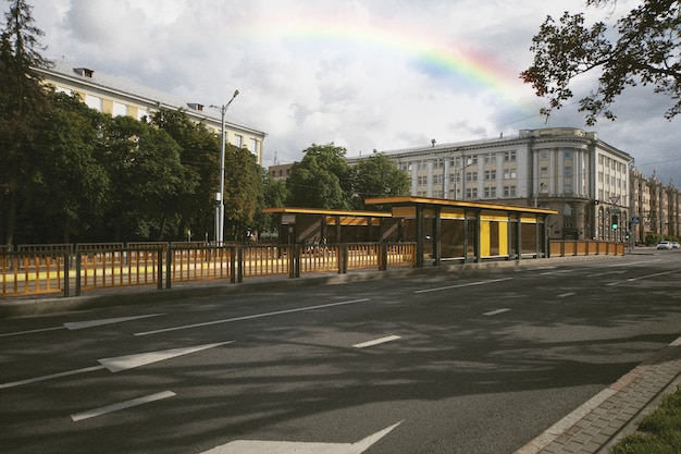 Free photo rainbow in the sky with view of the city