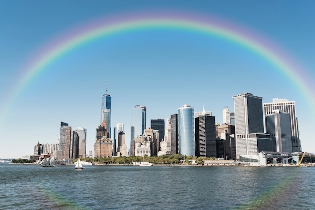 Free photo rainbow in the sky with view of the city